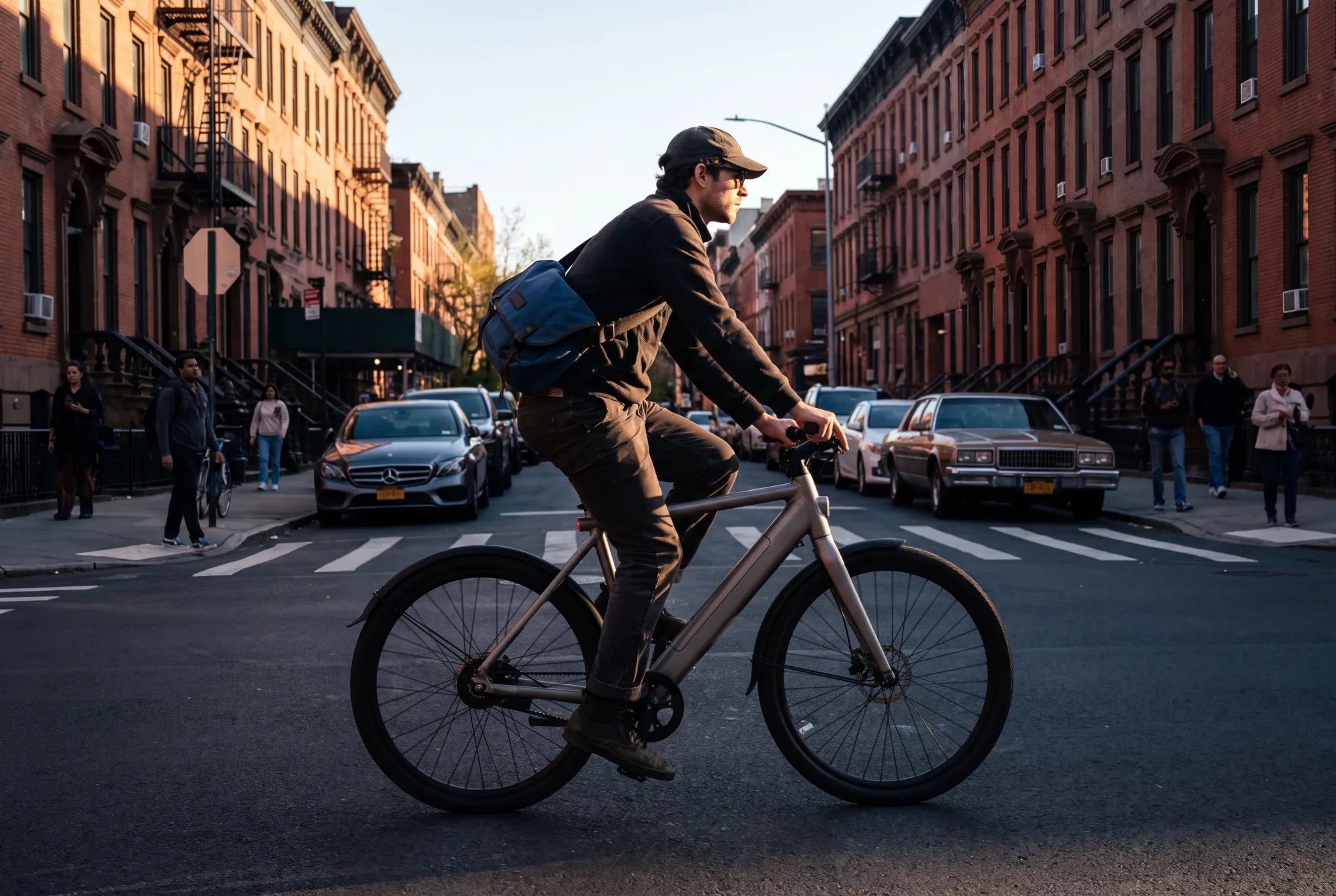 A cyclist on an e-bike in a United States city at golden hour